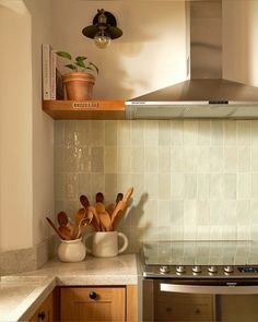 the kitchen counter is clean and ready to be used as a stove top oven with utensils on it