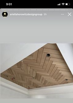 the ceiling is made out of wood planks and has an interesting pattern on it