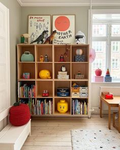 a child's playroom with bookshelves and toys on the shelves in it