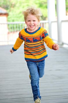 a little boy that is running down a sidewalk