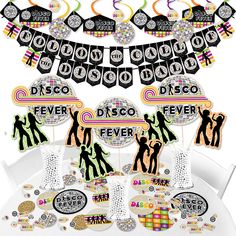 disco party decorations and tableware on a white table