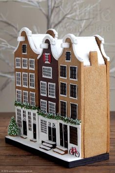 a gingerbread house with snow on the roof