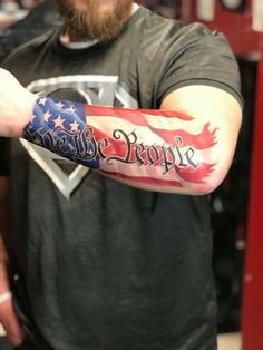 a man with an american flag tattoo on his arm