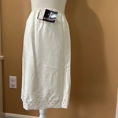 Lily Of France Vintage Skirt Slip Cream Size Small 100% Polyester Bottom Has Beautiful Embroidery Brand New With Original Tags! Elegant Cotton Skirt With Floral Embroidery, Elegant Embroidered Cotton Skirt, Elegant Cotton Skirt With Embroidery, Elegant Cotton Embroidered Skirt, Elegant White Skirt With Embroidered Hem, Elegant Embroidered Long Skirt, Elegant Bottoms With Embroidered Hem For Spring, Sleep Shirt Dress, Lingerie Gown