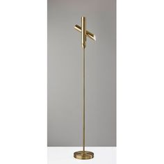 a gold floor lamp with a cross on the top and one light on the bottom