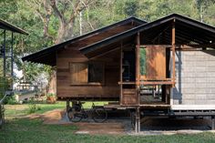 a small wooden house sitting on top of a lush green field