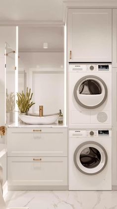 a washer and dryer in a white bathroom