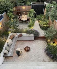 an aerial view of a small backyard garden with seating area and outdoor dining table in the center