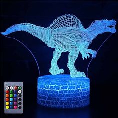 an illuminated dinosaur figure on top of a table