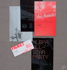 an assortment of different types of flyers and envelopes on a gray background with red lettering