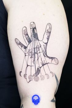 a person with a tattoo on their arm has a ring in it's hand