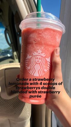 a person holding up a drink in front of a car with the caption order a strawberry lemonade with 4 scoops of strawberries double blended with strawberry puree