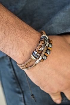 An array of metallic and wooden beads are knotted along mismatched strands of braided leather and shiny brown cording for a seasonal look. Features an adjustable sliding knot closure. Sold as one individual bracelet. P9UR-BNXX-420XX Casual Brown Beaded Braided Bracelets, Brown Braided Leather Bracelet In Bohemian Style, Casual Brown Braided Leather Bracelet, Casual Brown Leather Braided Bracelets, Casual Brown Leather Braided Bracelet, Bohemian Brown Leather Bracelet With Sliding Knot, Casual Brown Leather Strap Braided Bracelet, Hand Wrapped Brown Leather Jewelry, Braided Brown Leather Jewelry