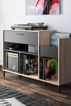 a record player is sitting on top of a shelf