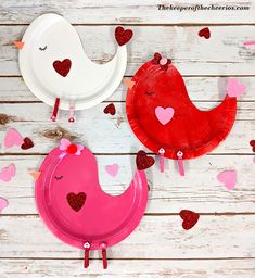 two paper plates with hearts and birds on them