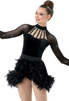 a woman in a black leotard and feathered skirt is posing for the camera