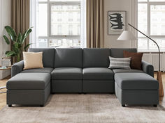 a living room with a large gray sectional couch