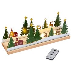 a remote control sitting next to a christmas scene