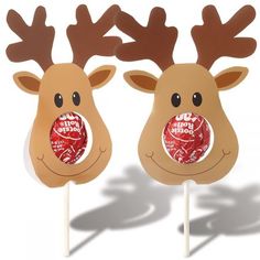 two reindeer shaped lollipops on top of sticks