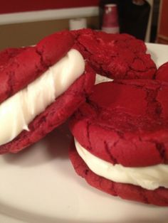 red velvet cookies with white frosting on a plate