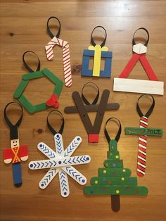 various craft items are arranged on a wooden table with scissors and other things in the shape of christmas trees