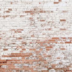 an old brick wall is painted red and white