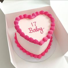 a heart shaped cake in a box with the word baby written on it