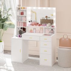 a white desk topped with lots of drawers and shelves filled with makeup items next to a potted plant