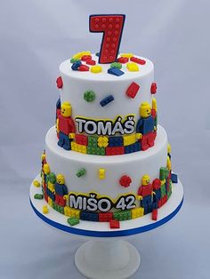 a white cake with legos on it and the number one for tom's miso 42