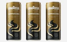 three cans of lavatta coffee with gold and black designs on the side, one is empty