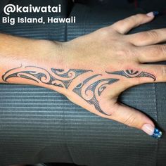 a woman's hand with a tattoo design on the middle of her left arm