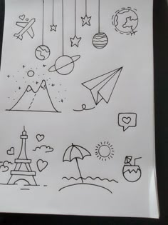 a piece of paper with drawings on it and an umbrella in the sky above them