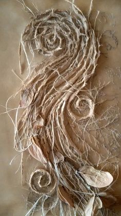 a piece of art that is made out of string and yarn with leaves on it