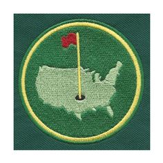 a green and yellow patch with a red flag on it