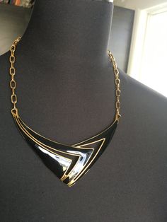 "Beautiful Monet statement necklace. Modernist design in a shiny gold tone and black enamel. CONDITION In excellent vintage condition. No wear, marks or damage. Closures are all secure The necklace measures approximately 20 inches and 1 3/4\" wide. The necklace is signed with © Monet. It is in excellent vintage condition Please see this section of my shop for more vintage costume jewelry: https://www.etsy.com/shop/ChrisandTine?section_id=17309162 My full shop: http://www.chrisandtine.etsy.com Pr Black Enamel 14k Gold Necklace, Vintage Enamel Necklace With Large Pendant, Luxury Black Enamel Statement Necklace, Vintage Yellow Gold Enamel Necklace, Luxury Vintage Black Enamel Necklace, Black Choker, Brass Necklace, Vintage Costume Jewelry, Black Enamel