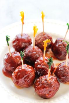 small appetizers with toothpicks in sauce on a white plate, ready to be eaten