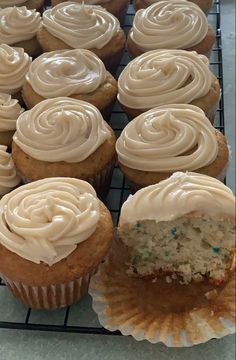 cupcakes with frosting sitting on a cooling rack