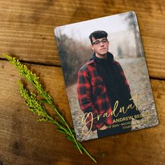 a card with an image of a man on it next to some flowers and leaves