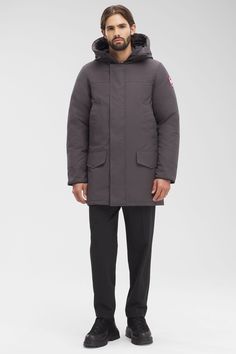 The Langford gets an update with streamlined hood adjustment, additional drop-in pockets, and added backpack straps. This stylish urban piece is similar to the Chateau parka but is slightly longer for greater leg protection. With a storm flap over the centre front zipper and two interior pockets, Langford offers clean lines and a modern look - all in an uncompromisingly protective parka. Customize your parka and extend the coverage of your hood with a variety of our interchangeable Hood Trim accessories.​ Functional Hooded Parka For Work, Functional Hooded Parka For Workwear, Winter Travel Outerwear With Storm Flap, Classic Parka With Detachable Hood For Cold Weather, Urban Down Parka With Detachable Hood, Fitted Outdoor Parka With Pockets, Classic Outdoor Parka With Detachable Hood, Journey Boots, Functional Down Parka With Double-lined Hood