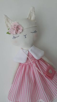 a stuffed animal wearing a pink and white dress