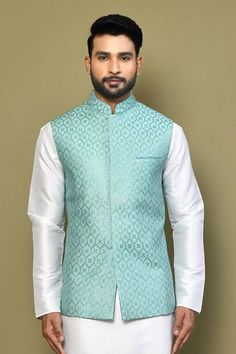 Blue sleeveless bundi with all over sequin fleur jaal embroideries. Paired with a white full sleeves plain kurta and a pant. - Aza Fashions Designer Wear Fitted Nehru Jacket With Self Design, Fitted Nehru Jacket With Self Design For Diwali, Fitted Nehru Jacket With Self Design For Festive Occasions, Fitted Nehru Jacket With Self Design For Festive, Designer Self-design Fitted Nehru Jacket, Festive Fitted Nehru Jacket With Self Design, Fitted Festive Vest With Zari Work, Festive Fitted Vest With Zari Work, Fitted Sleeveless Outerwear For Festive Occasions