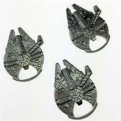 three pieces of star wars themed brooches on a white surface with space shuttles in the center