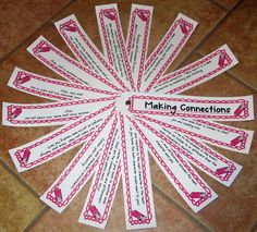 some pink and white paper tags with writing on them sitting on a tile floor next to a tiled floor