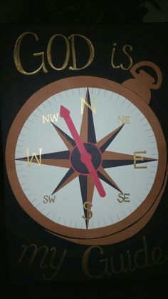 a compass with the words god is my guide written in gold ink on it's black background