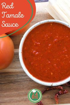 a bowl of red tomato jamale sauce next to some tomatoes on a cutting board