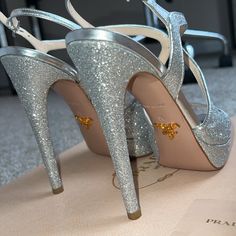 Description: Elevate Your Style With These Dazzling Prada Glitter Donna Short Platform Heels, A Statement Piece That Combines Luxury With Bold Fashion. Designed For Those Who Dare To Stand Out, These Heels Are A Testament To Prada’s Commitment To Craftsmanship And Avant-Garde Design. Key Features: Brand: Prada Size: Us 6 Condition: Brand New, Never Worn, And In Impeccable Condition, These Heels Come Ready To Add Sparkle And Sophistication To Your Wardrobe. Material: Full Glitter Embellishment, Offering A Stunning, Eye-Catching Appearance That Catches The Light With Every Step. Design: Elegantly Designed With A 6-Inch Heel And A Subtle Platform, Providing An Exqui Luxury Glitter Accented Heels For Party, Luxury Party Heels With Glitter Accents, Designer Sparkling High Heels, Luxury Glitter Accented Heels For Gala, Luxury Glitter Heels For Gala, Designer Glitter Heels For Party, Luxury Silver Glitter Heels, Designer Sparkling Heels For Party, Luxury Glitter Heels With Round Toe