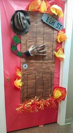 a door decorated to look like a scarecrow's house with hands on it