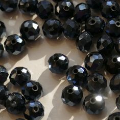 many black beads are laying on the table