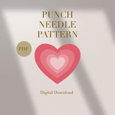 a pink heart sitting on top of a table next to a white wall with the words punch needle pattern