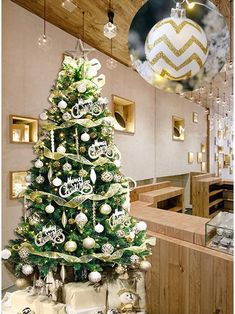 a decorated christmas tree sitting in the middle of a room next to a counter top